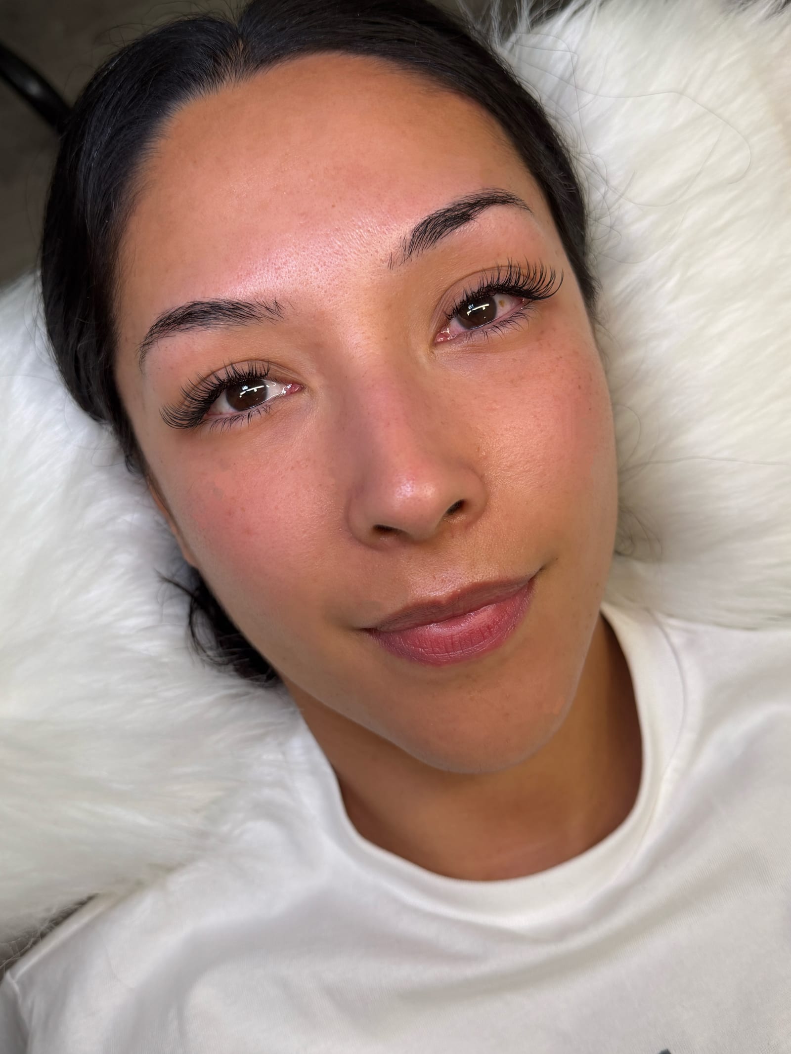 Reclining portrait showing a Classic lash set.